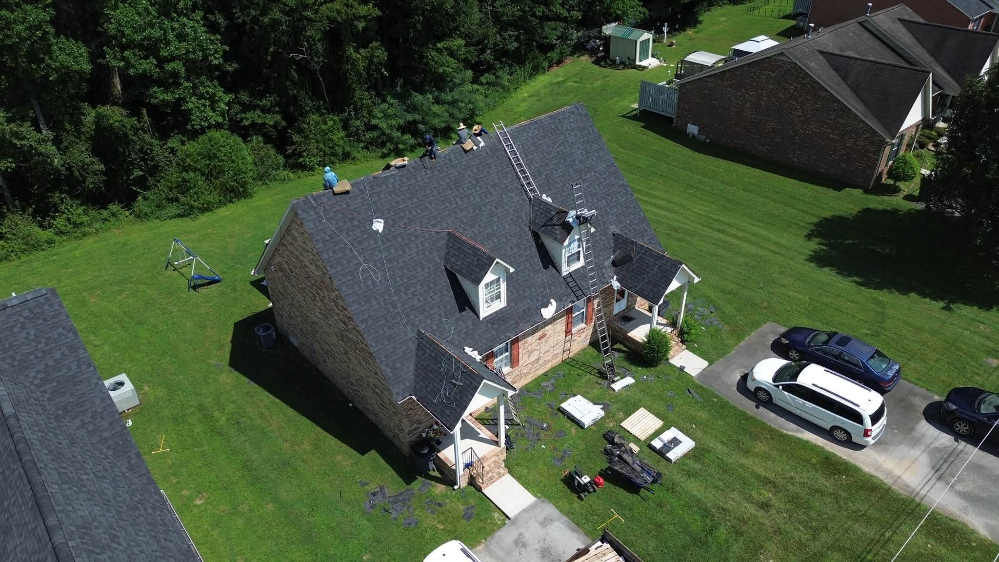 A brick house with a new roof.